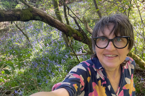 Marianne im Wald mit Hasengl&ouml;ckchen im Hintergrund